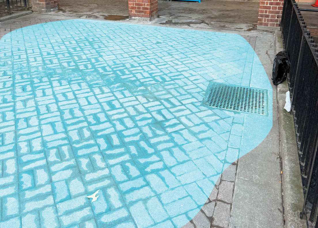 Patches of sidewalk covered in dirt show previous extents of flooding